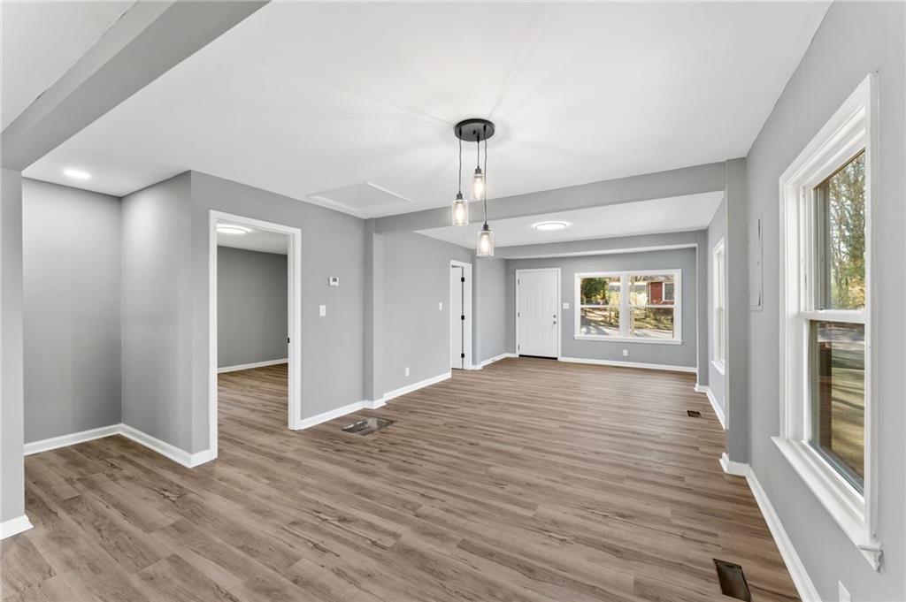 407 East 19th Street Rome, GA 30161 - Photo 5 of 17 a view of an empty room with wooden floor and a window
