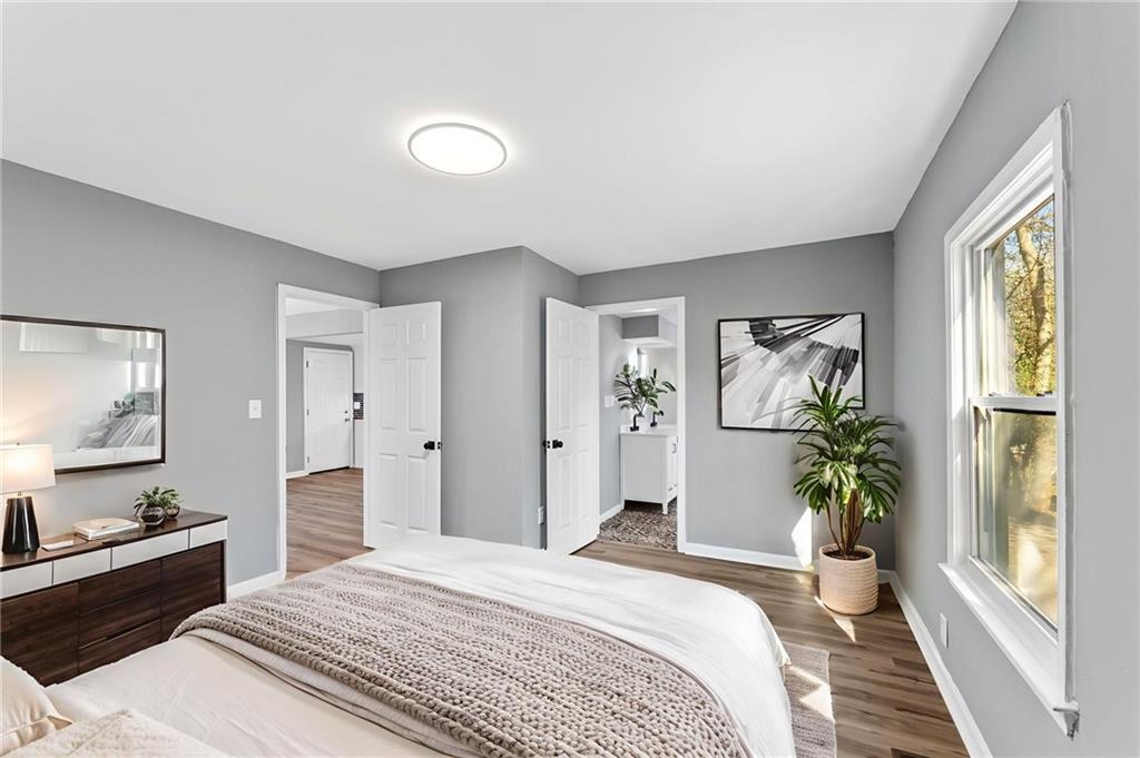 407 East 19th Street Rome, GA 30161 - Photo 8 of 17 a bedroom with a bed and a large window