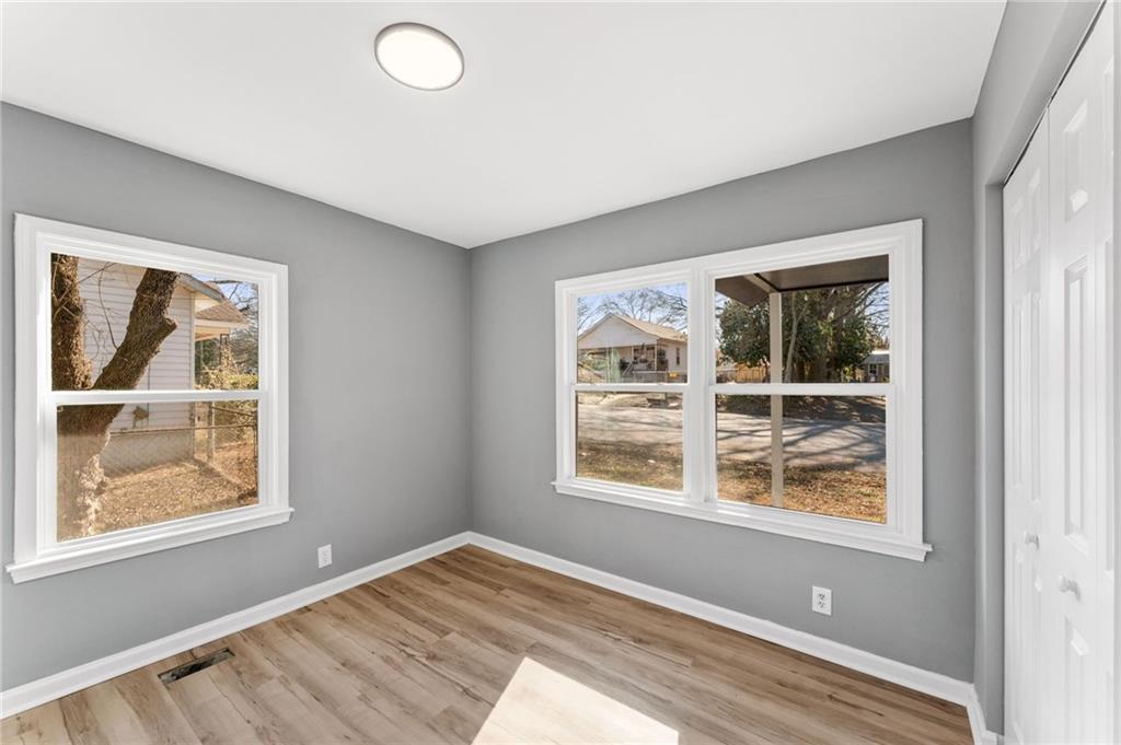407 East 19th Street Rome, GA 30161 - Photo 10 of 17 a view of empty room with window and wooden floor