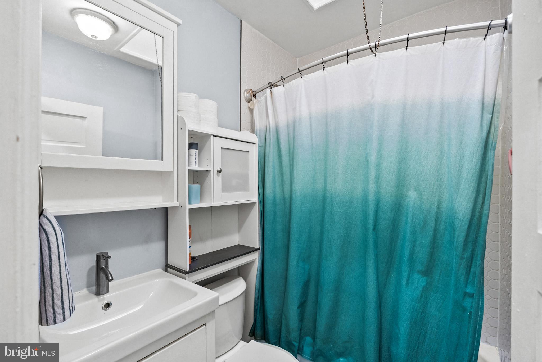 2422 2nd Street Northeast Washington, DC 20002 - Photo 24 of 40 a bathroom with a shower curtain and a sink