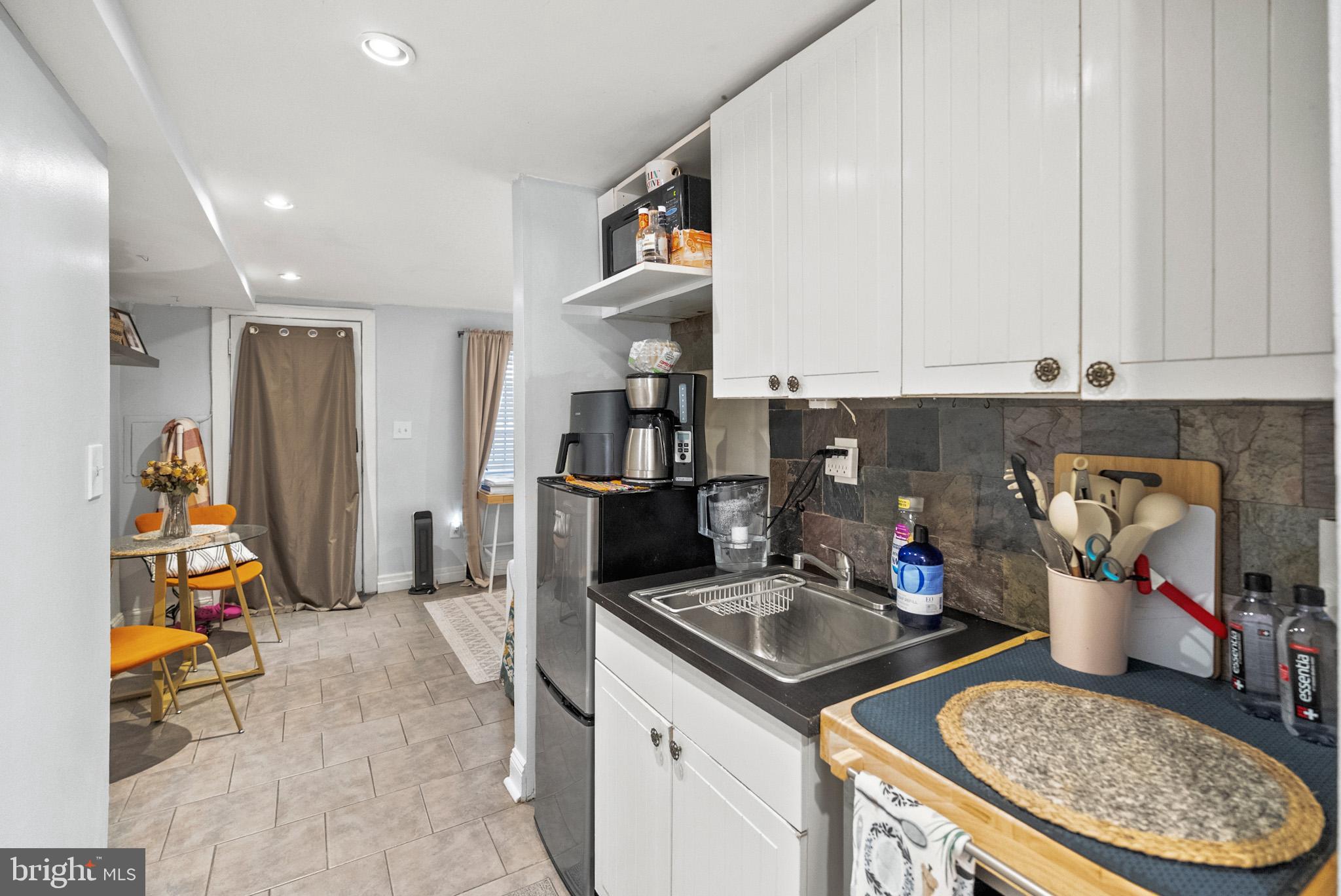2422 2nd Street Northeast Washington, DC 20002 - Photo 28 of 40 a kitchen with stainless steel appliances granite countertop a sink a stove and a refrigerator