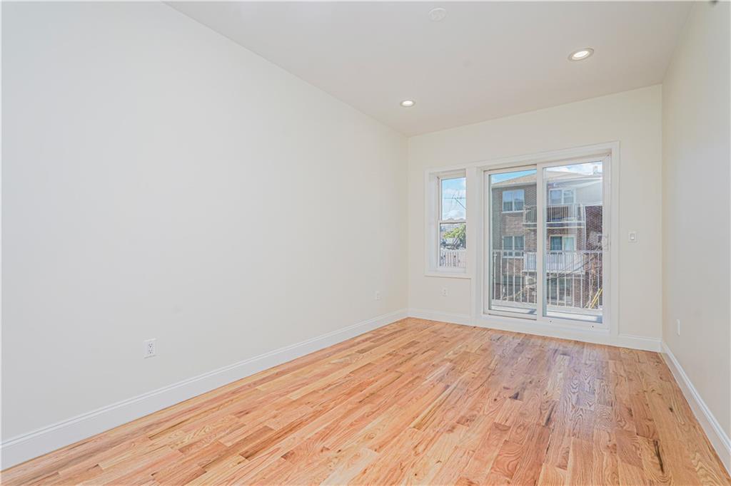 160 Bay 29th Street Brooklyn, NY 11214 - Photo 17 of 27 an empty room with wooden floor and windows