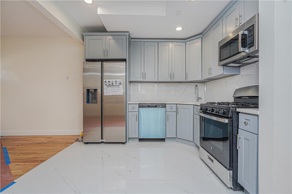 160 Bay 29th Street Brooklyn, NY 11214 - Photo 4 of 27 a kitchen with stainless steel appliances granite countertop a refrigerator oven a sink and dishwasher