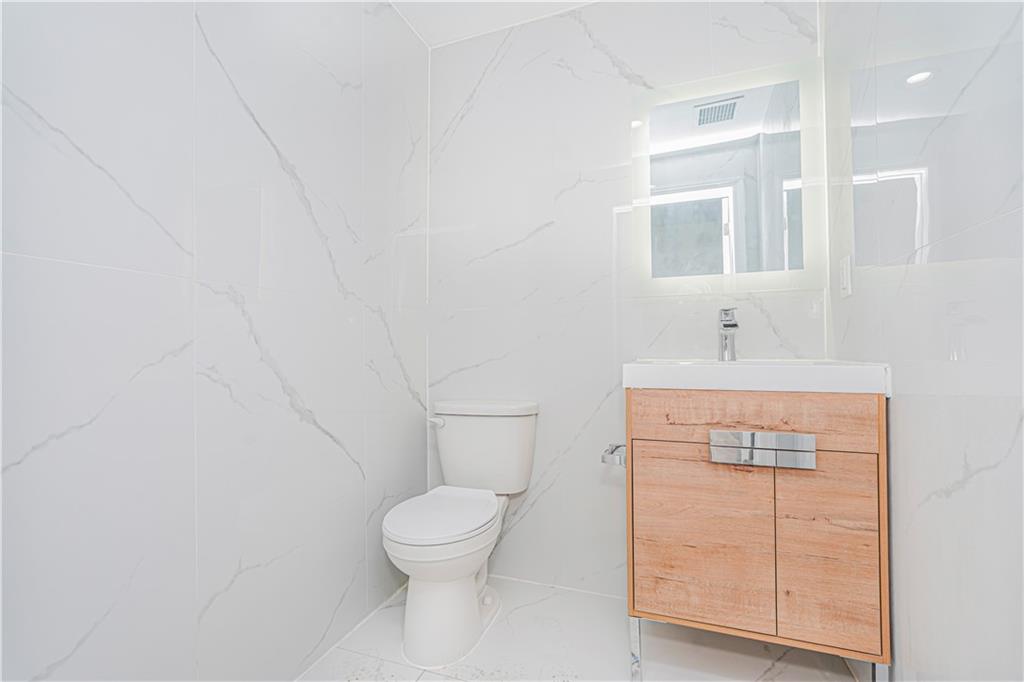 160 Bay 29th Street Brooklyn, NY 11214 - Photo 9 of 27 a bathroom with a toilet sink and vanity