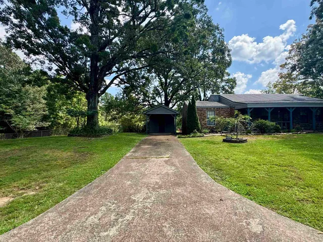 a front view of house with yard and green space
