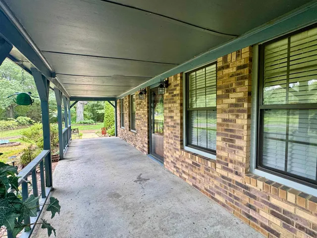 a view of a porch with wooden floor and outdoor space