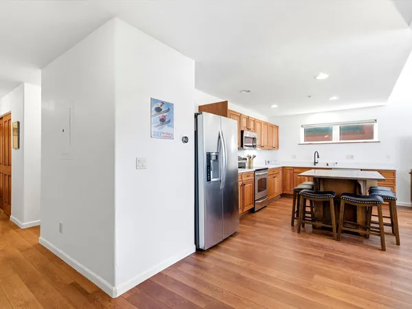 a kitchen with stainless steel appliances a refrigerator and a stove top oven