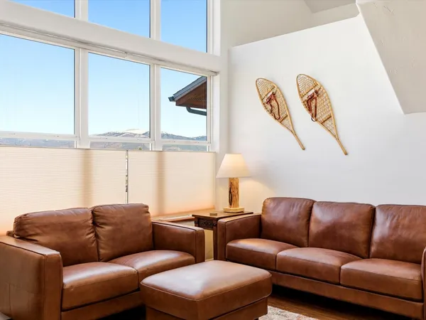 a blue couch sitting next to a window