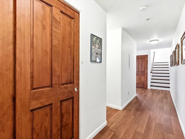 a view of a hallway with wooden floor
