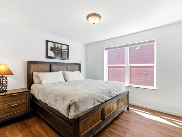 a bed sitting in a bedroom next to a window