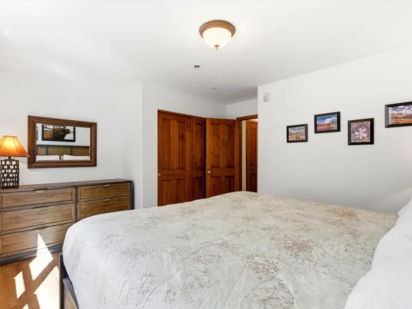 a bedroom with a large bed and a dresser