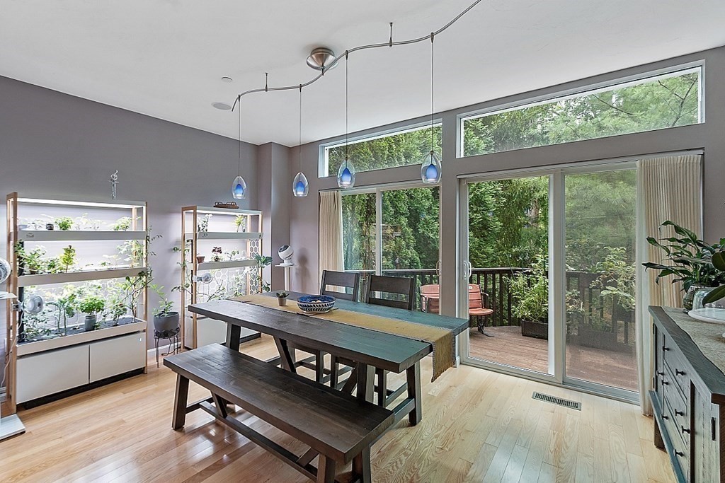 47 Deer Path, Unit 47 Hudson, MA 01749 - Photo 12 of 42 a living room with furniture a flat screen tv and a floor to ceiling window