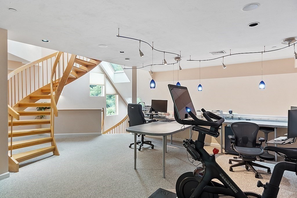 47 Deer Path, Unit 47 Hudson, MA 01749 - Photo 19 of 42 a room with gym equipment and wooden floor