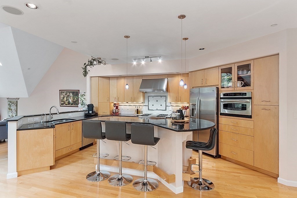 47 Deer Path, Unit 47 Hudson, MA 01749 - Photo 2 of 42 a kitchen with stainless steel appliances kitchen island granite countertop a sink and cabinets