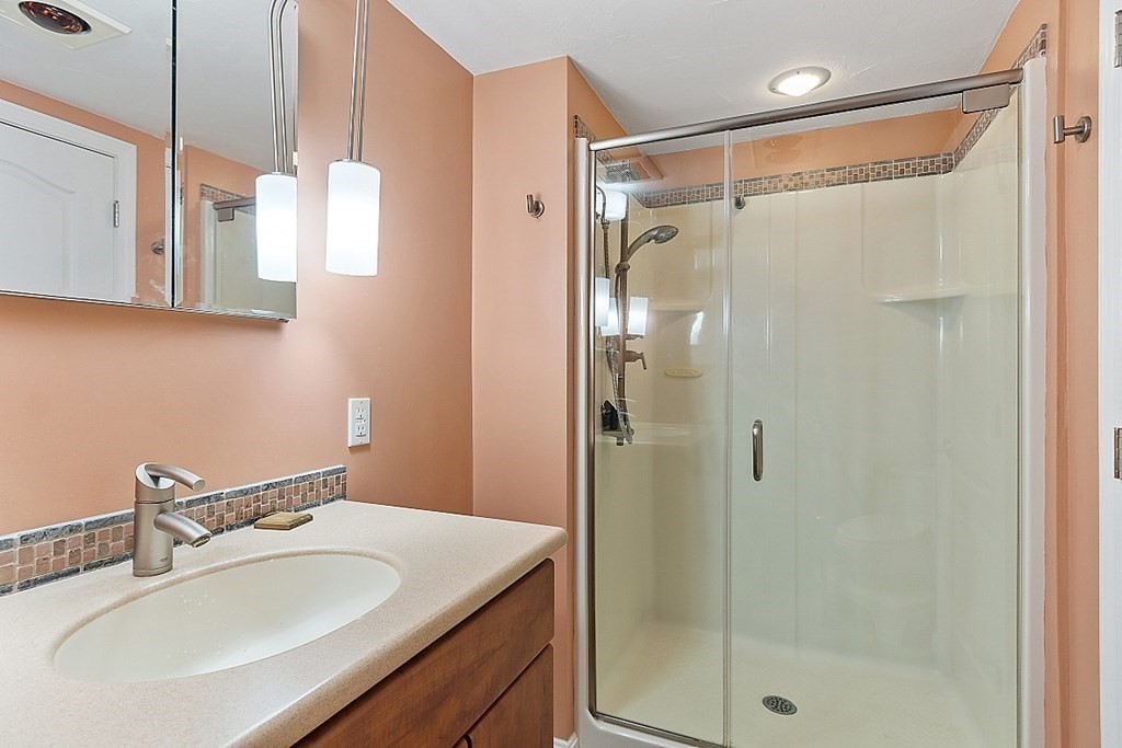 47 Deer Path, Unit 47 Hudson, MA 01749 - Photo 24 of 42 a bathroom with a sink shower and a mirror