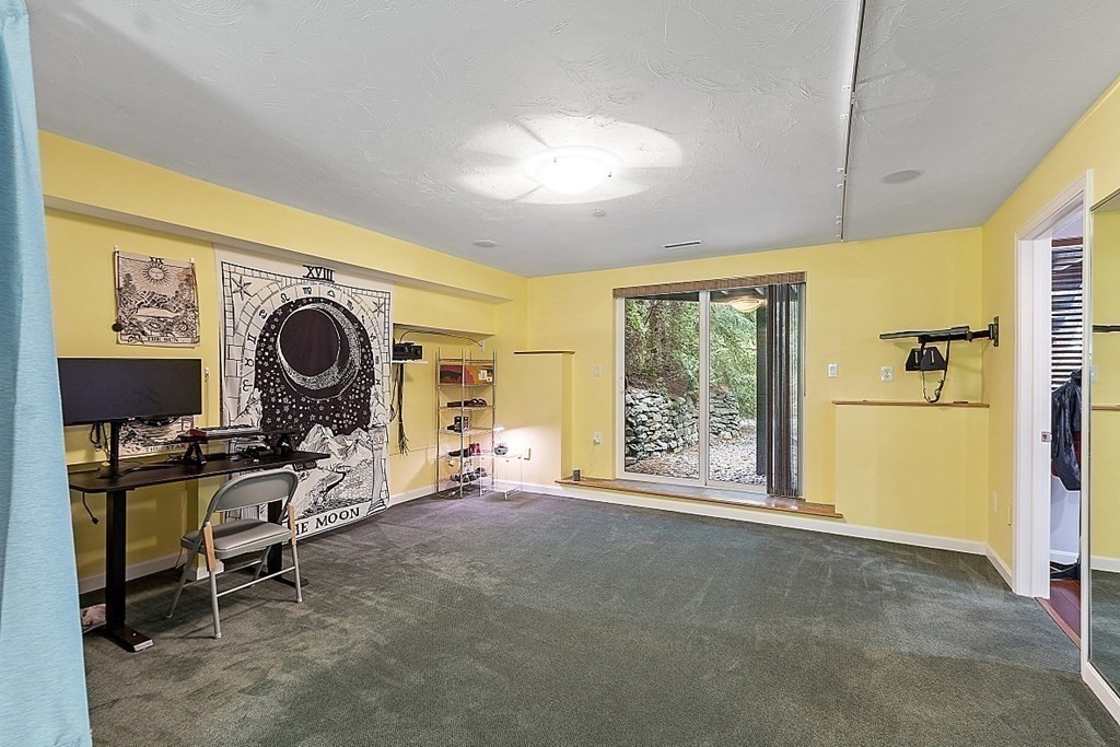 47 Deer Path, Unit 47 Hudson, MA 01749 - Photo 31 of 42 a view of a room with gym equipment