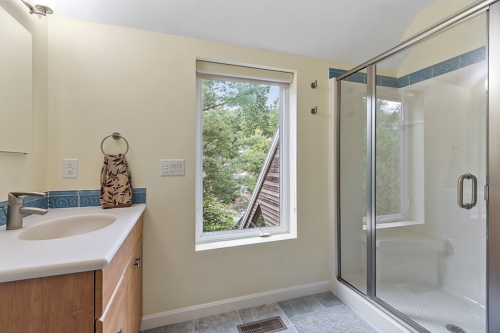 47 Deer Path, Unit 47 Hudson, MA 01749 - Photo 35 of 42 a bathroom with a sink mirror and window