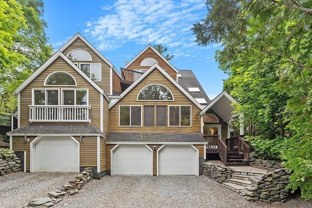 47 Deer Path, Unit 47 Hudson, MA 01749 - Photo 37 of 42 a front view of a house with a yard and garage