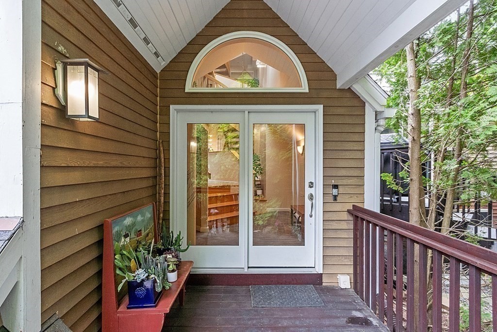 47 Deer Path, Unit 47 Hudson, MA 01749 - Photo 4 of 42 a view of a house with a large window and wooden fence