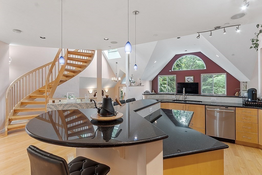 47 Deer Path, Unit 47 Hudson, MA 01749 - Photo 5 of 42 a view of a kitchen with kitchen island granite countertop a sink a counter top space and living room view