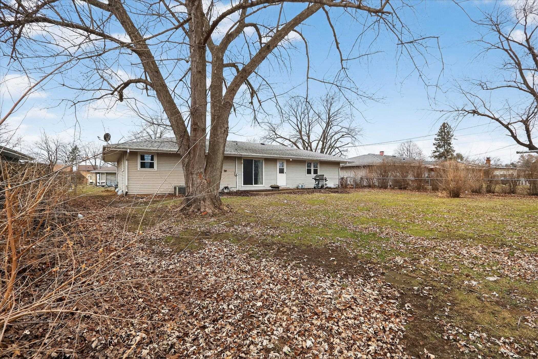 a large tree in front of a house