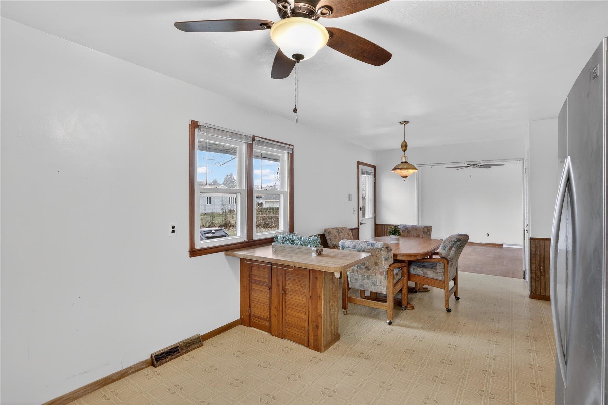 6962 Ralph Road Rockford, IL 61109 - Photo 12 of 35 a view of a dining room with furniture window and wooden floor
