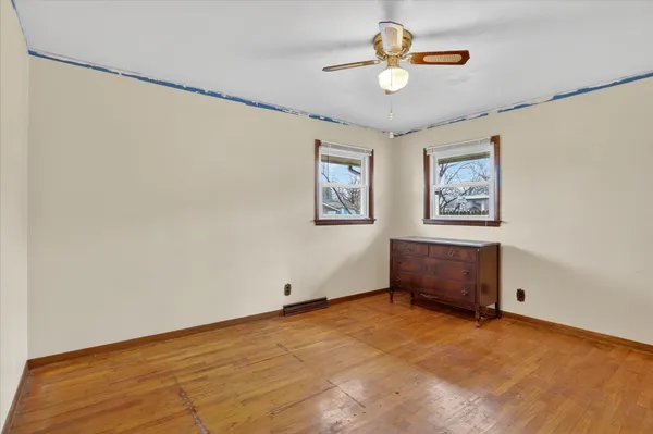 a view of a livingroom with a ceiling fan and window