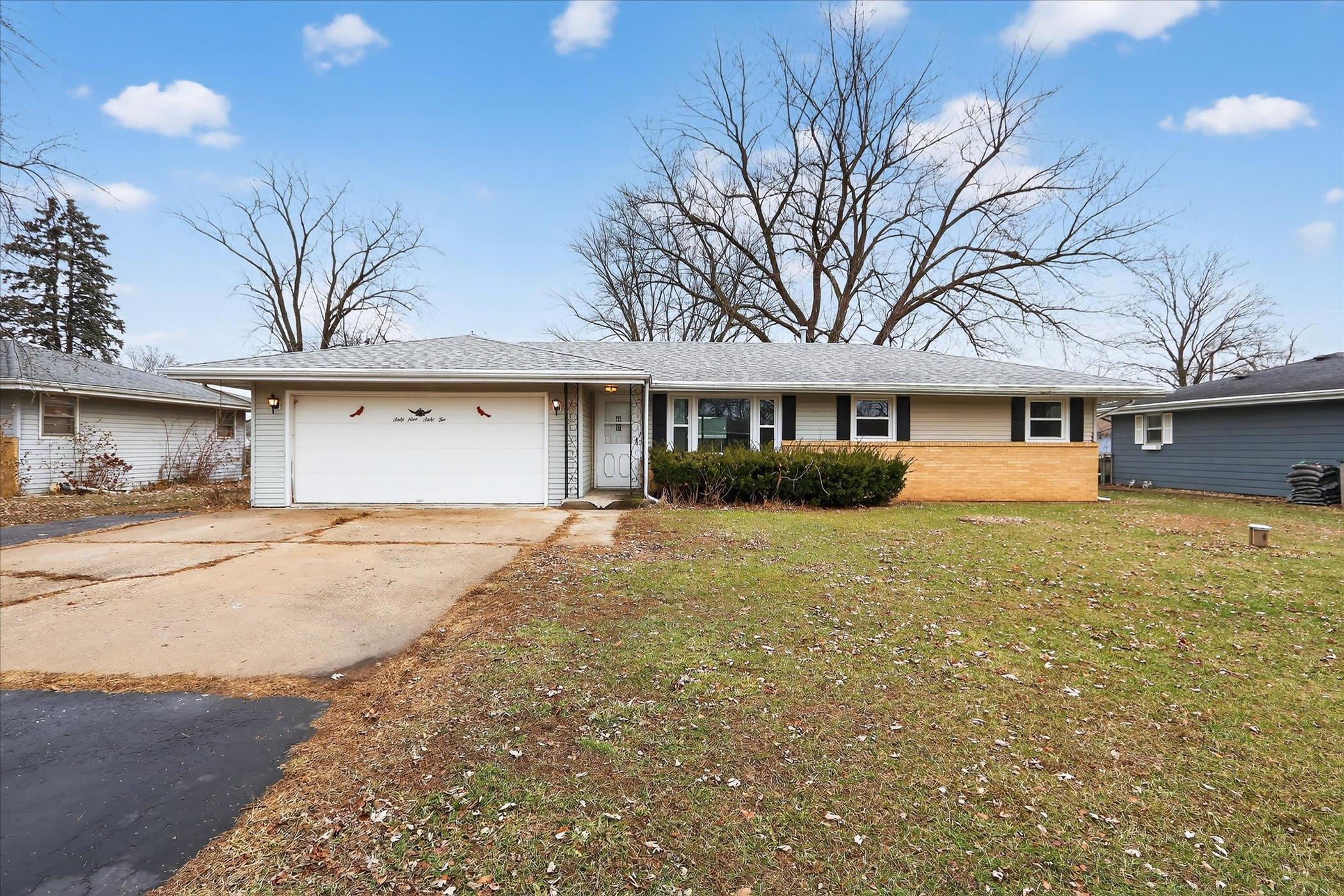 6962 Ralph Road Rockford, IL 61109 - Photo 27 of 35 a front view of a house with a yard and garage