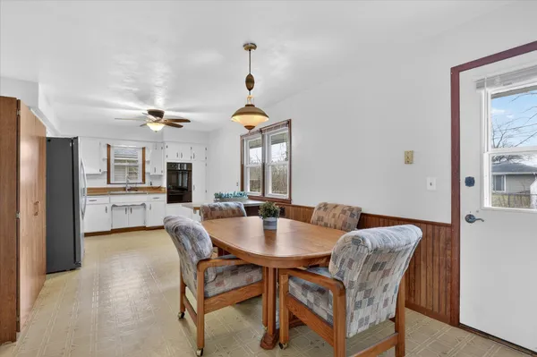a dining room with furniture and window