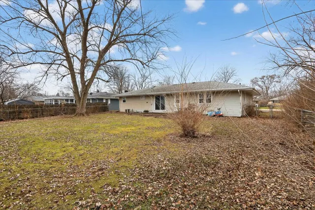 a front view of house with yard and trees