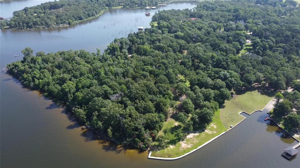 24 Sycamore Street Yantis, TX 75497 - Photo 2 of 6 an aerial view of a house with a yard and lake view