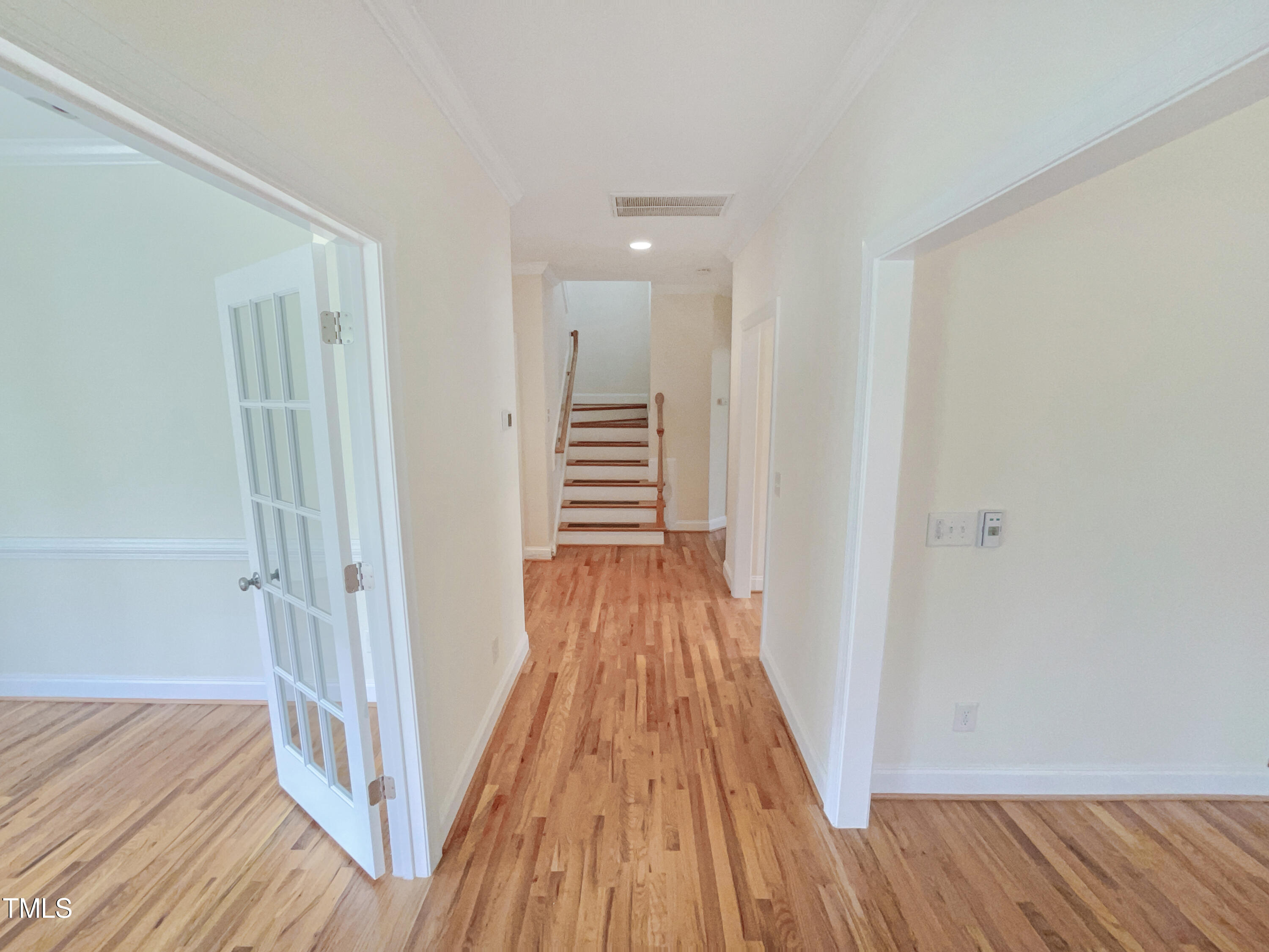 582 Canvas Drive Wake Forest, NC 27587 - Photo 4 of 16 a view of a hallway with wooden floor and staircase
