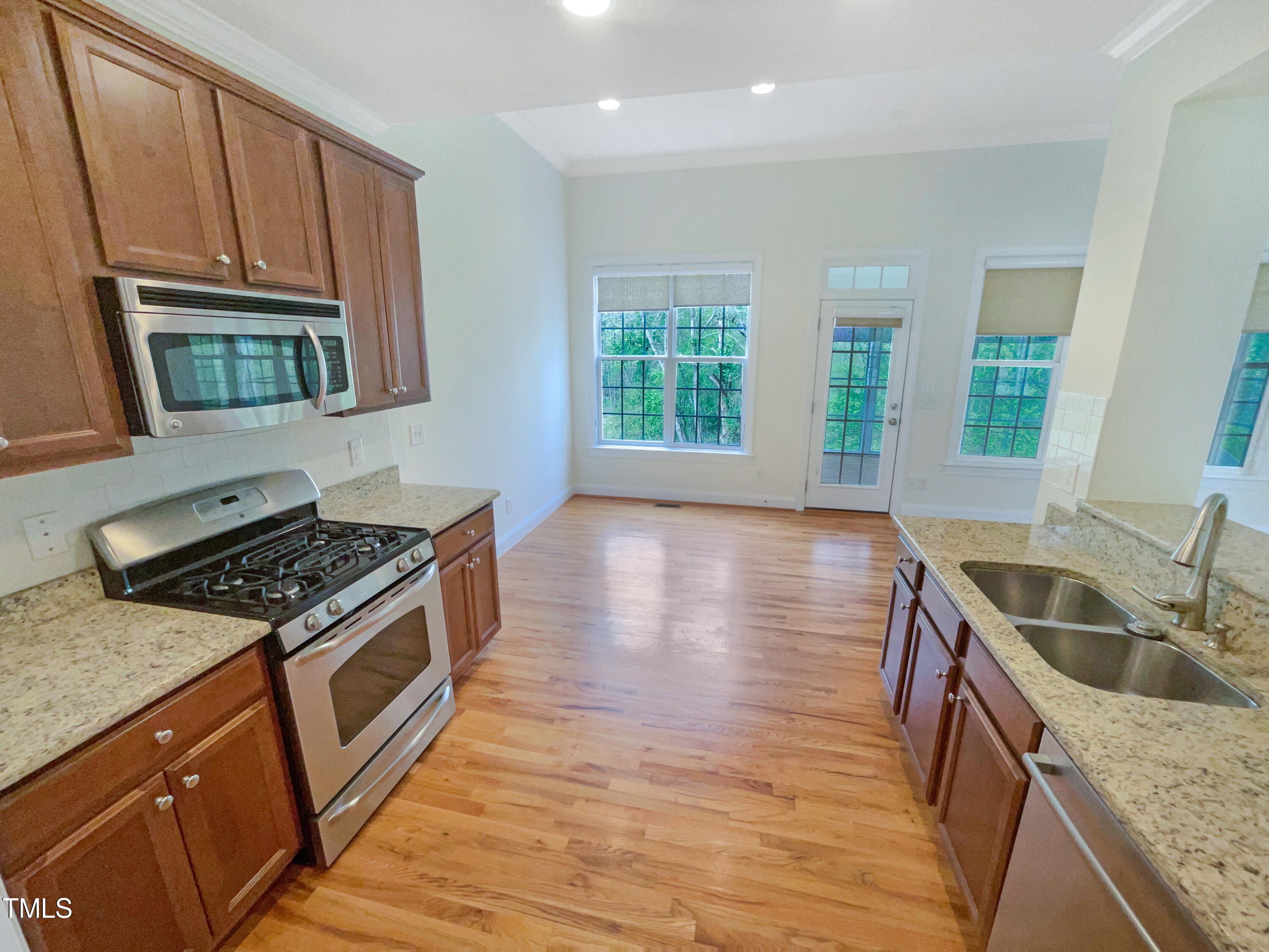 582 Canvas Drive Wake Forest, NC 27587 - Photo 9 of 16 a kitchen that has a sink wooden floor and a stove