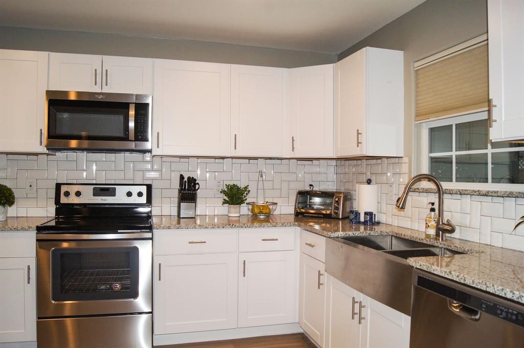 1727 Pueblo Street Dallas, TX 75212 - Photo 10 of 27 a kitchen with cabinets stainless steel appliances and a sink