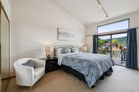a bedroom with a bed and a large window
