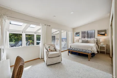 a spacious bedroom with a bed and a couch