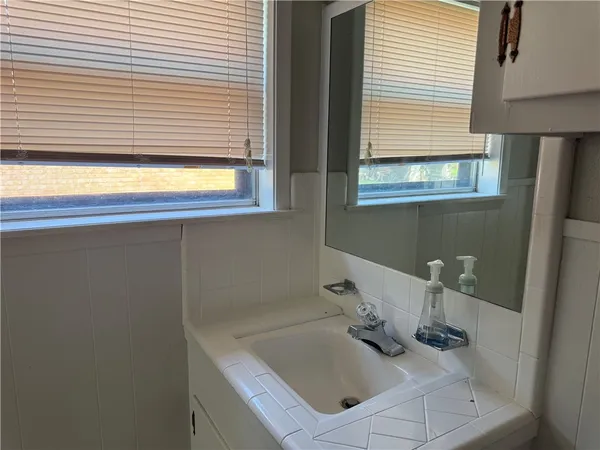 a bathroom with a sink and a window