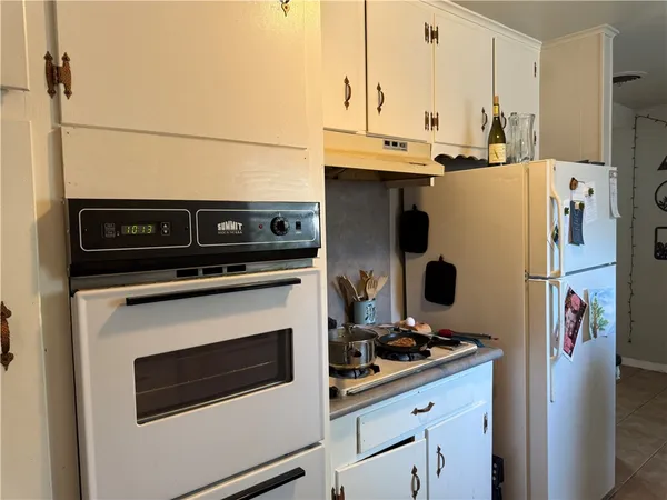 a kitchen with stainless steel appliances a stove a refrigerator and a counter top