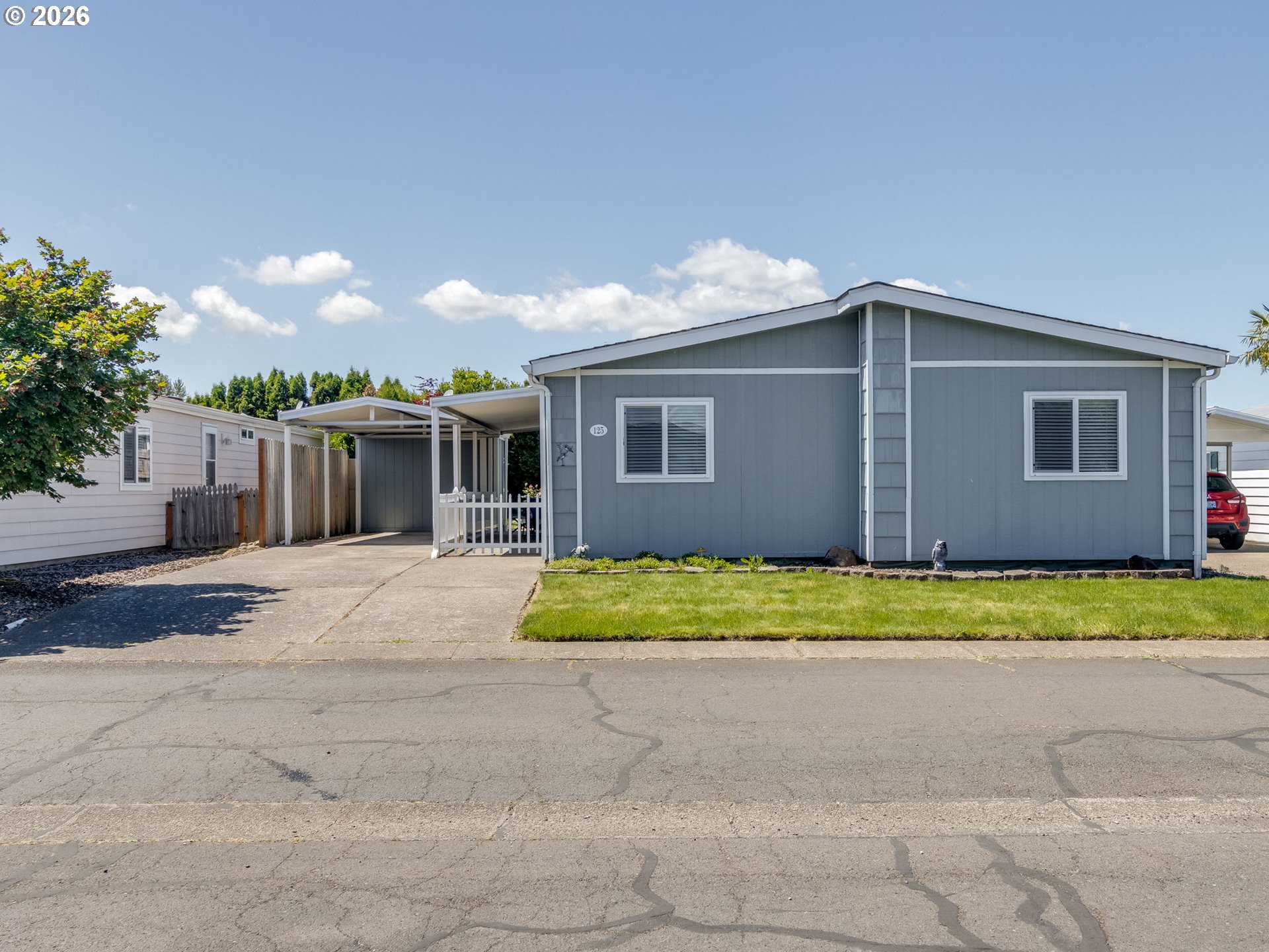 4730 Auburn Road Northeast, Unit 125 Salem, OR 97301 - Photo 1 of 36 a house with a big yard and large trees