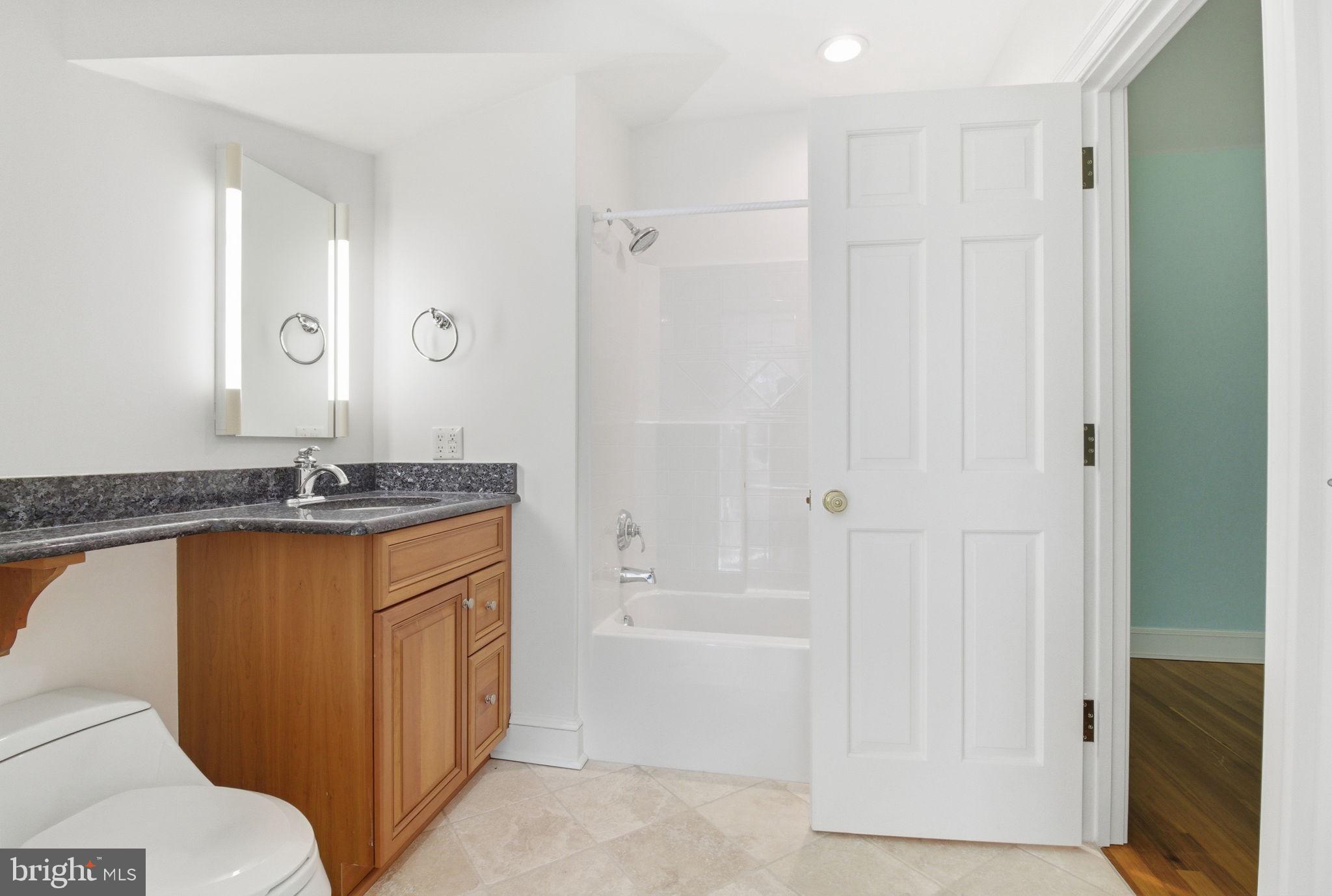 1711 Highland Road Fredericksburg, VA 22401 - Photo 24 of 58 a bathroom with a granite countertop sink a toilet and shower
