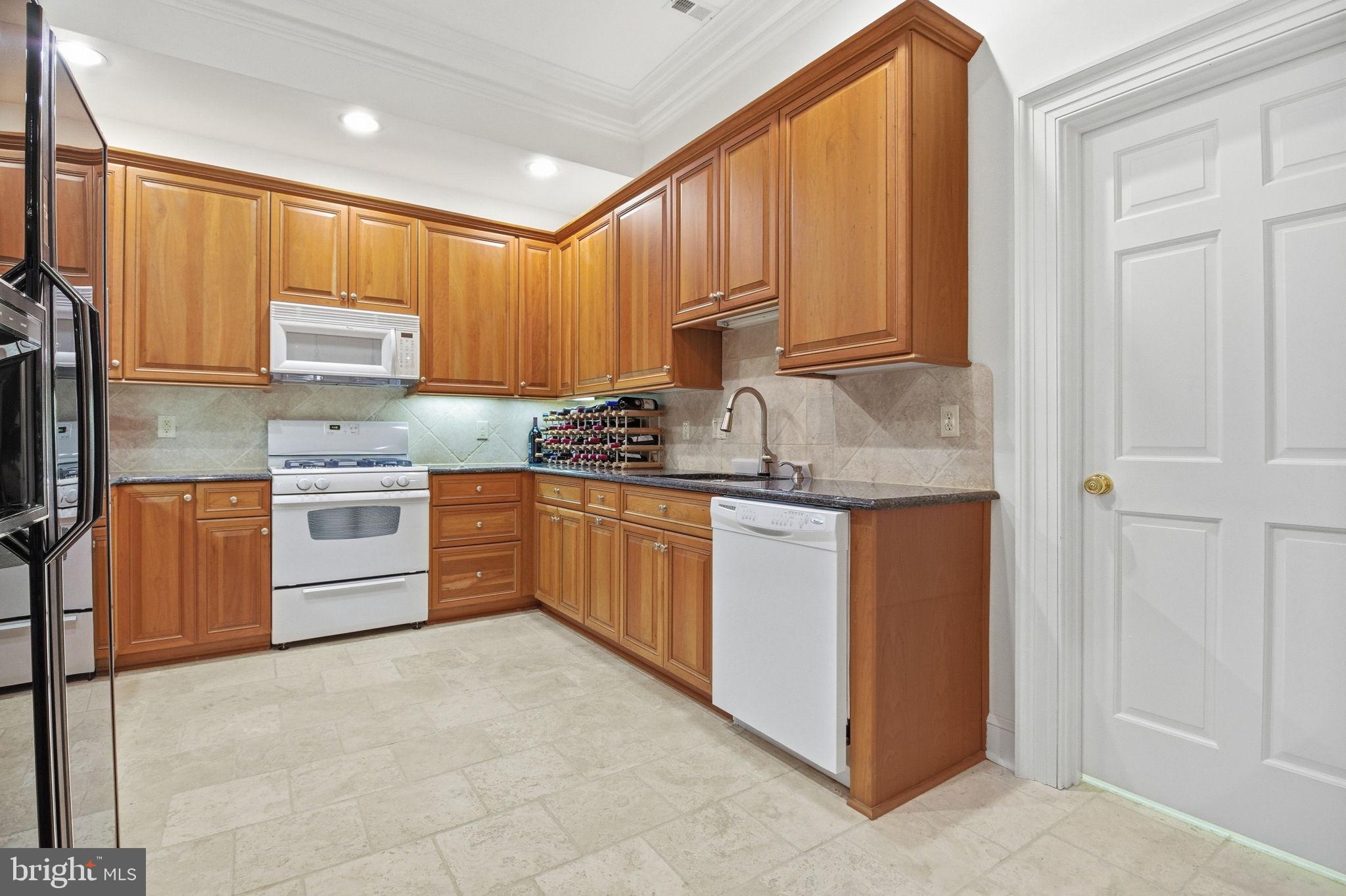 1711 Highland Road Fredericksburg, VA 22401 - Photo 31 of 58 a kitchen with stainless steel appliances granite countertop a stove a sink and a refrigerator