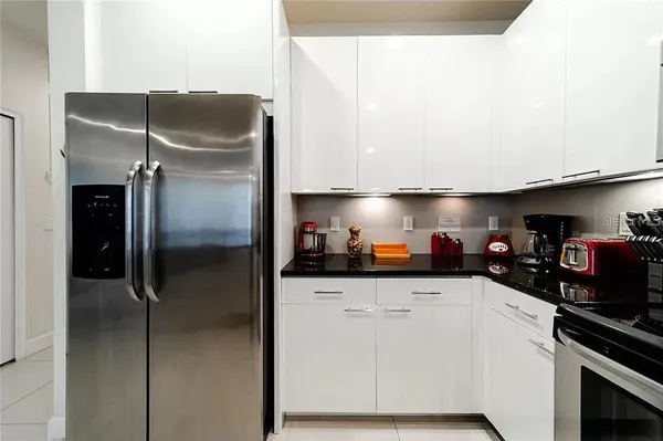 a kitchen with stainless steel appliances a sink and a refrigerator