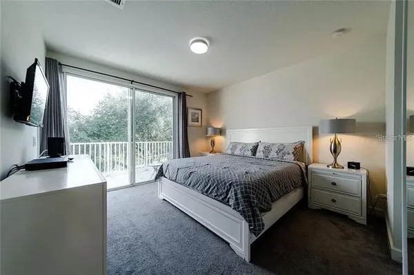 a spacious bedroom with a bed and large window