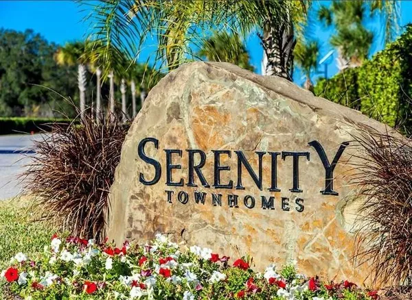 a view of sign board with flower plants
