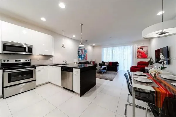 a kitchen with stainless steel appliances kitchen island granite countertop a sink and cabinets