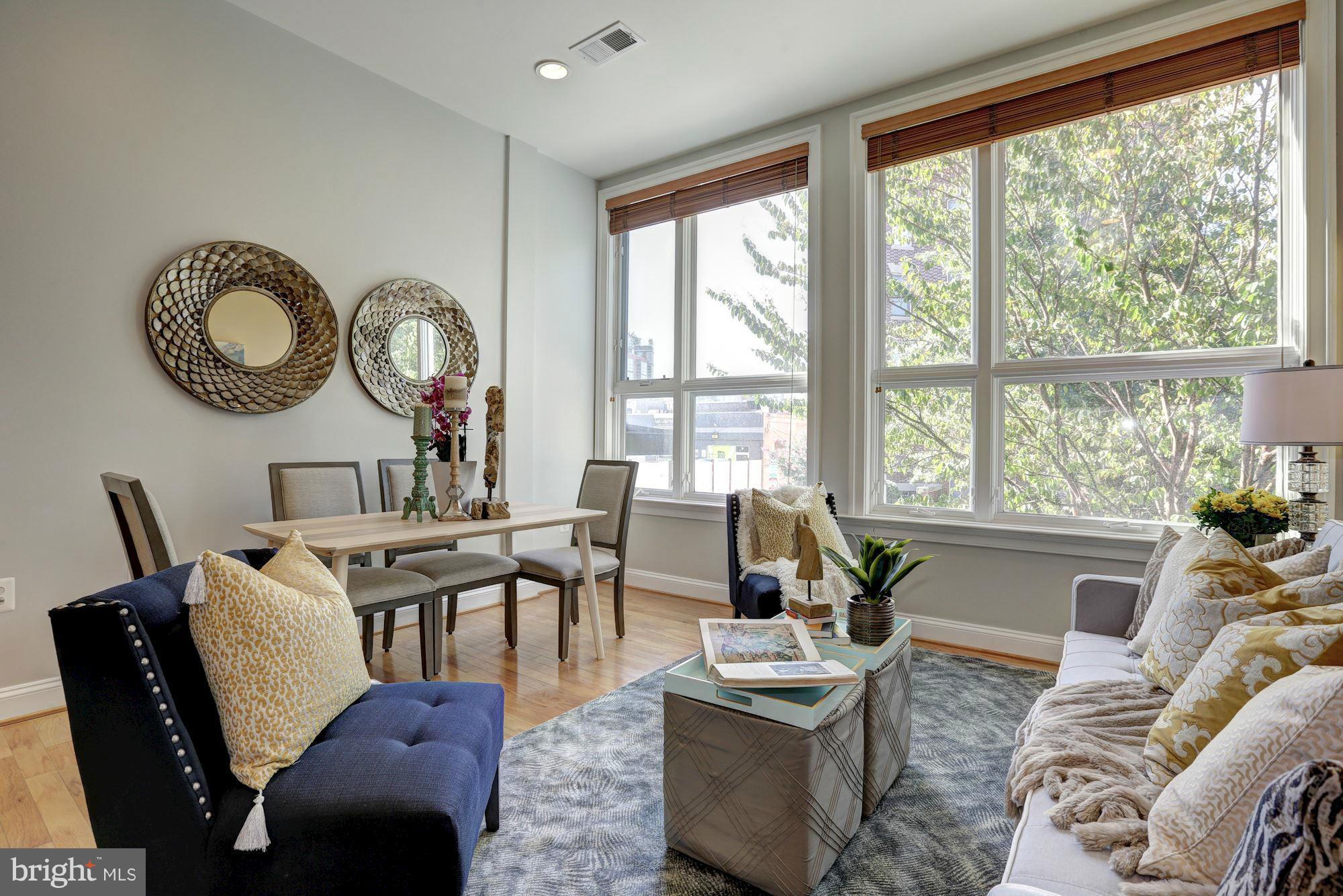 1407 W Street Northwest, Unit 202 Washington, DC 20009 - Photo 13 of 30 a living room filled with furniture and a large window
