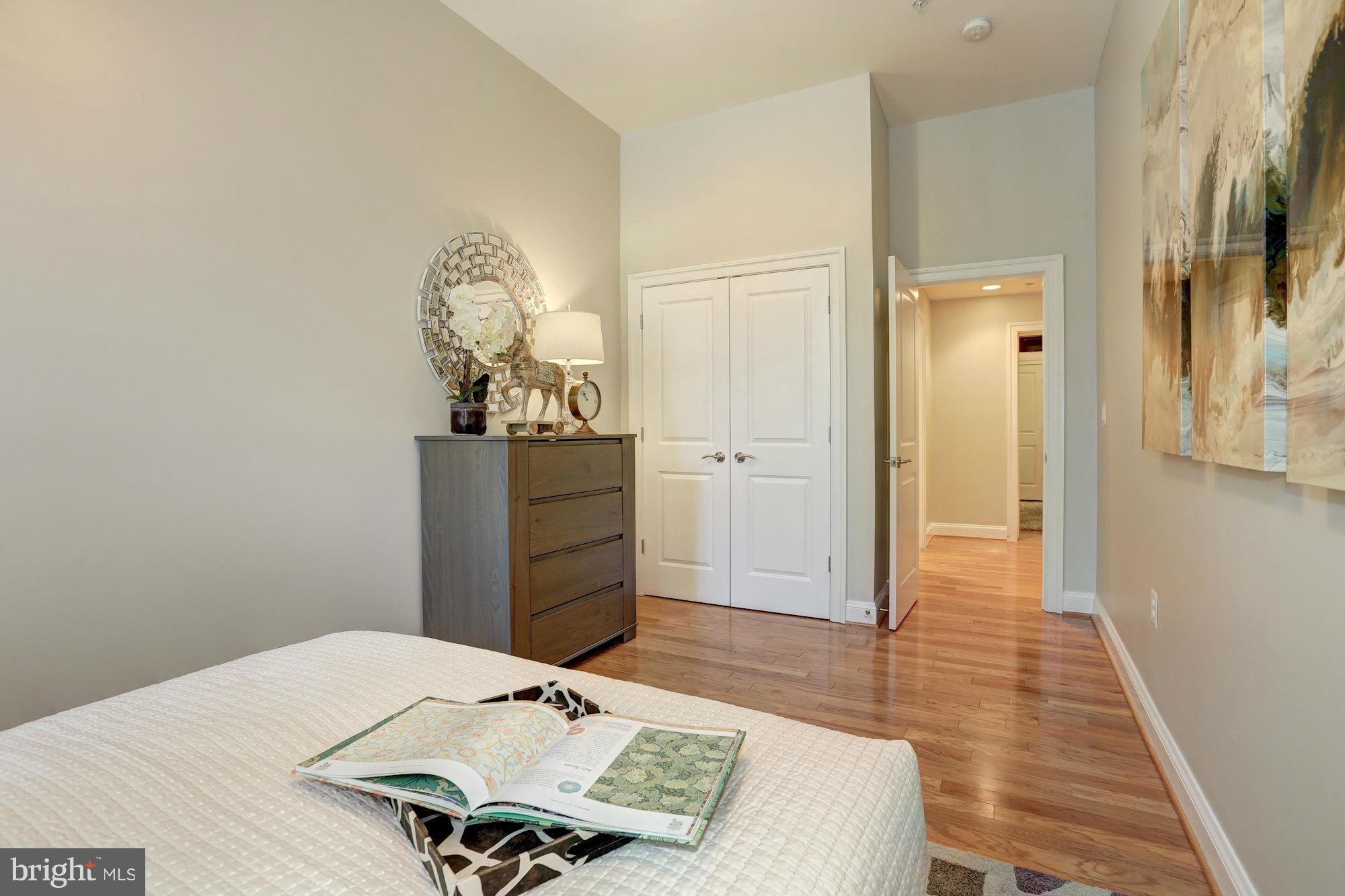 1407 W Street Northwest, Unit 202 Washington, DC 20009 - Photo 20 of 30 a bed room with a bed mirror and a table