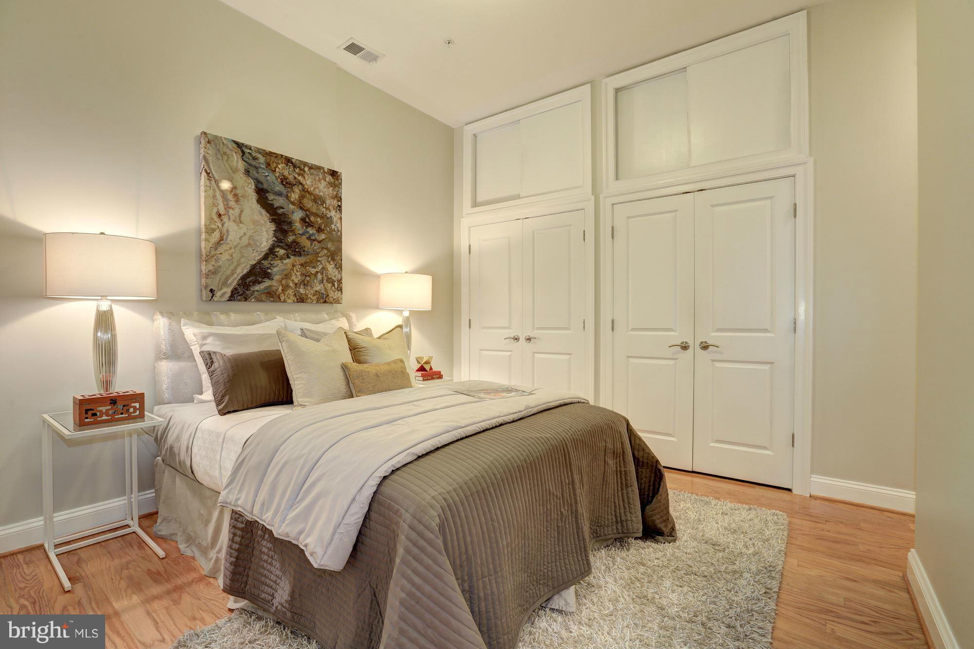 1407 W Street Northwest, Unit 202 Washington, DC 20009 - Photo 21 of 30 a bedroom with a bed and a walk in closet