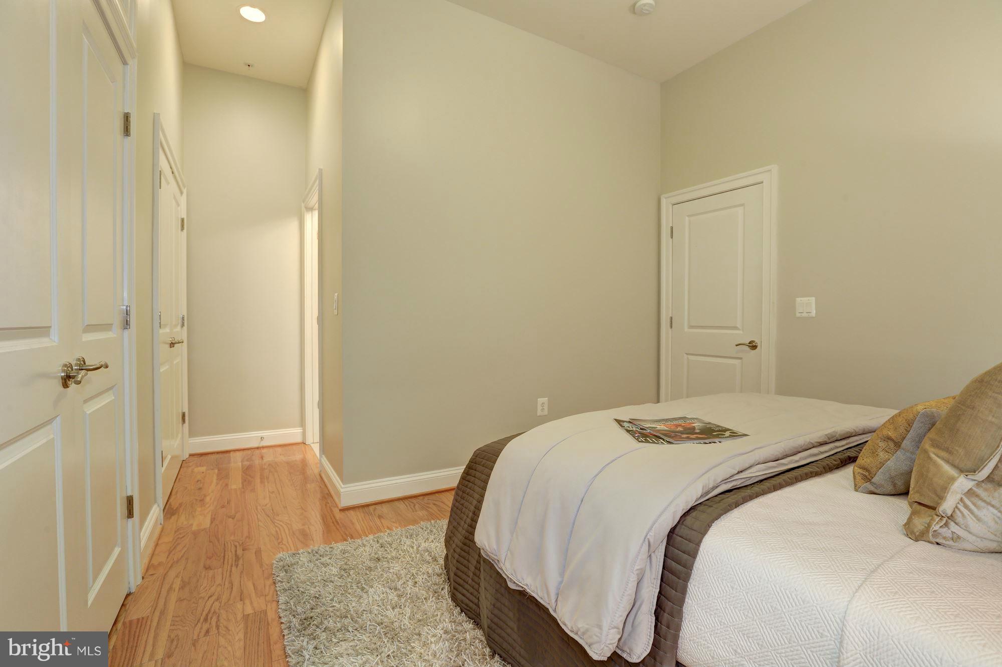 1407 W Street Northwest, Unit 202 Washington, DC 20009 - Photo 22 of 30 a bedroom with a bed and a table