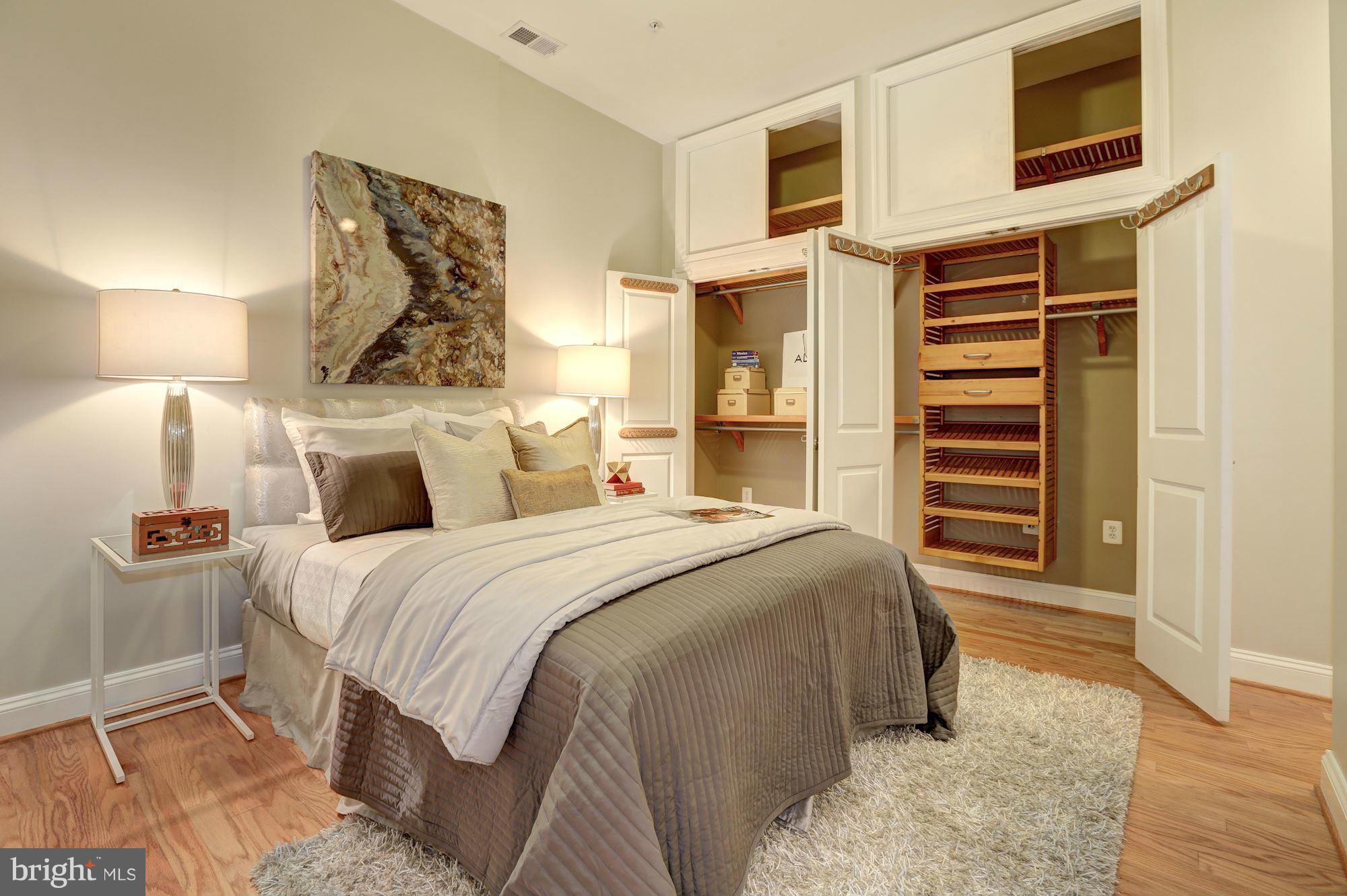 1407 W Street Northwest, Unit 202 Washington, DC 20009 - Photo 23 of 30 a bedroom with a bed and a chandelier